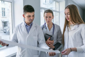 Three doctors are looking at a paper